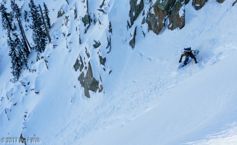 Snowboarder dropping into the Cirque.