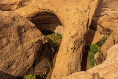 View from the rim looking down about 250' to the top of Jacob Hamblin's Arch.  The other amphitheater is on the left.