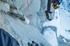 Perhaps the worst anchor stance I've ever rappelled off of.  The anchor was position just over a lip of a small roof so that it wasn't just free hanging, but undercut for the feet.  I used a small cam off to my left to keep my feet on something.  Micah earning his money by doing the free hanger.