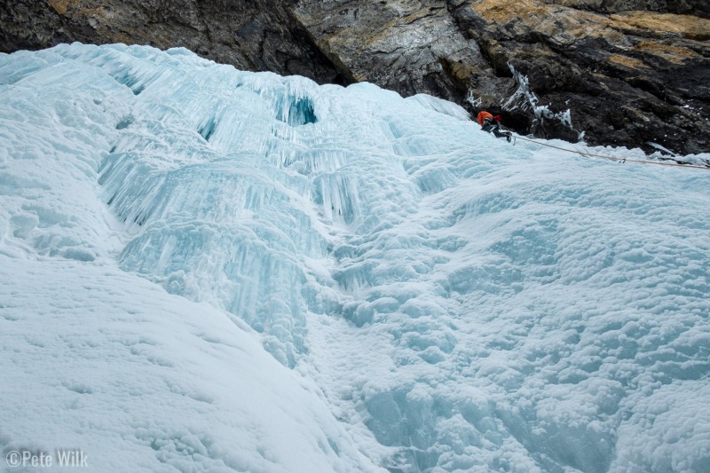 The geology of the area is limestone with water channels from the ice field on top.  Water ends up popping out of random caves.  Ice Palace ends in a cavern.